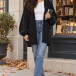 Oversized Open-Front Cardigan Review: ATHMILE Woman browsing a bookstore in the ATHMILE black oversized open-front cardigan