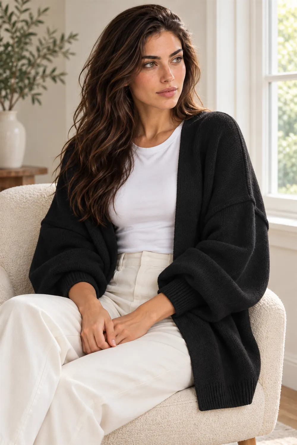 ATHMILE black open-front cardigan worn by a window
