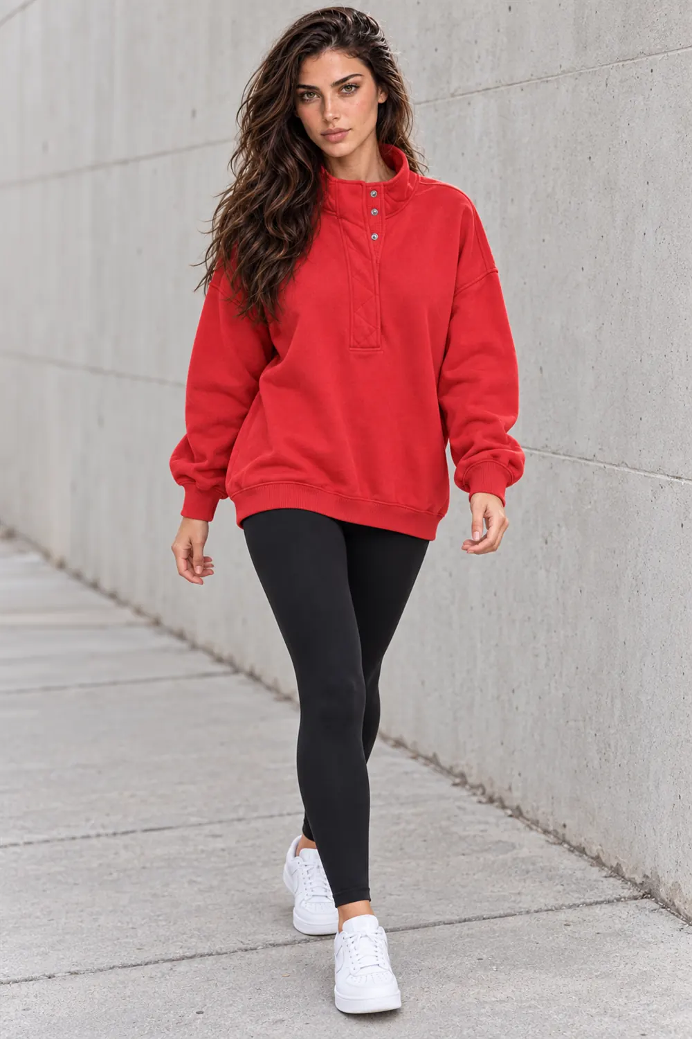 Woman crossing a city street in the Gacaky red Henley sweatshirt and jeans